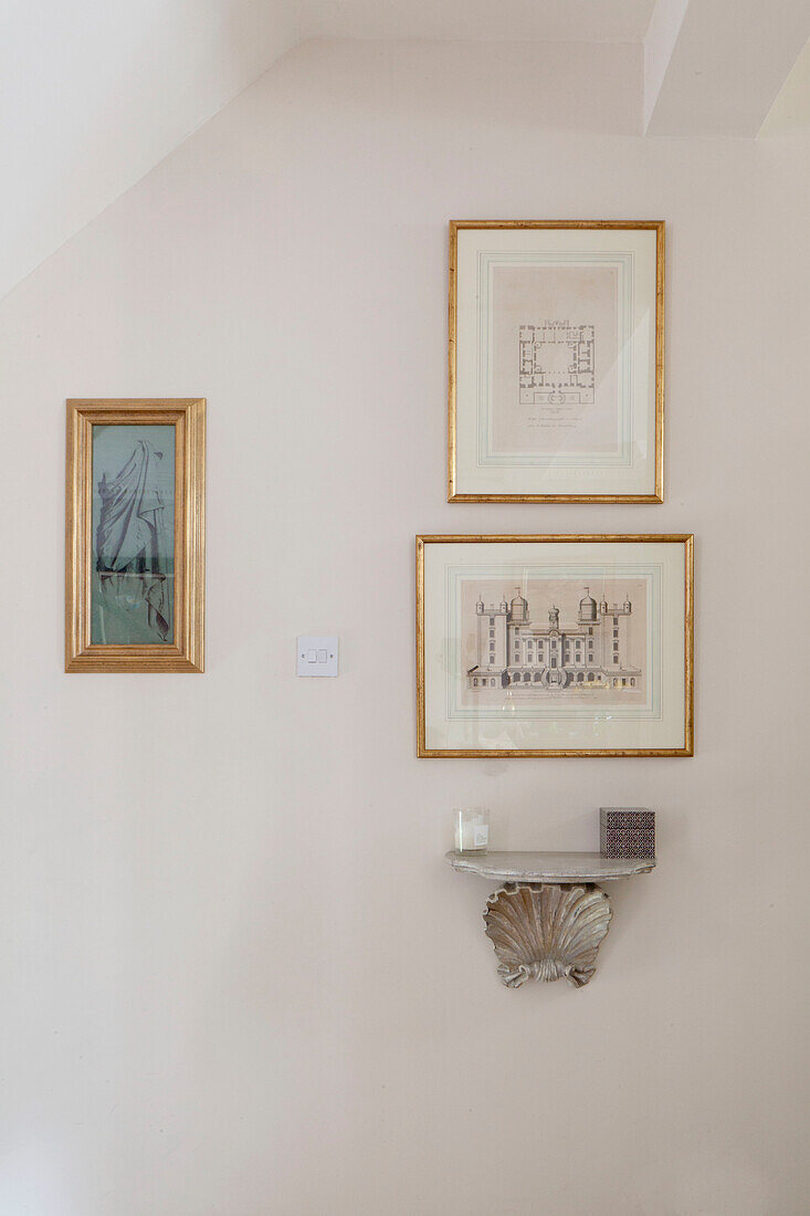 Gilt framed artwork with small silver shelf in Chelsea home London UK