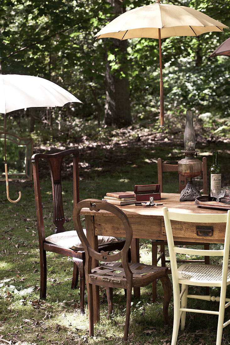 Parasols shading table and chairs in garden, UK
