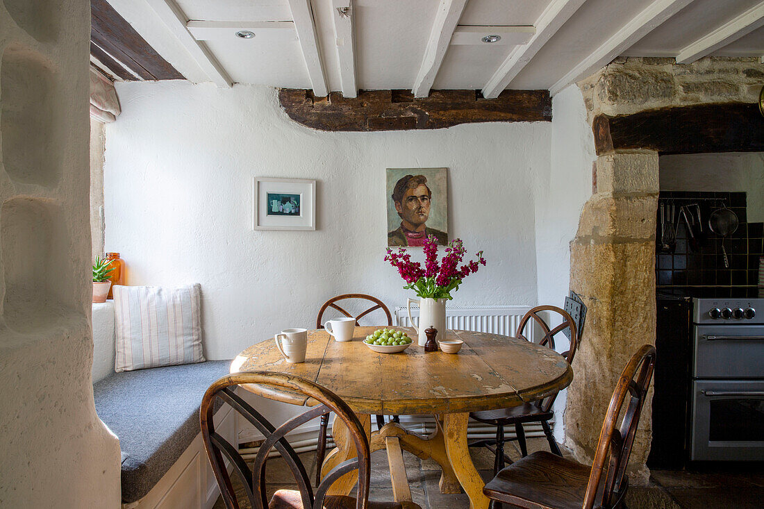 Holztisch und -stühle mit Fensterplatz in einem Bauernhaus in Cirencester Gloucestershire UK
