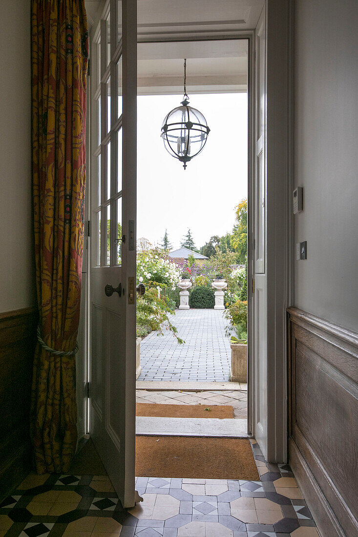 Door curtain hangs behind open front door of Georgian Grade II listed Surrey home UK
