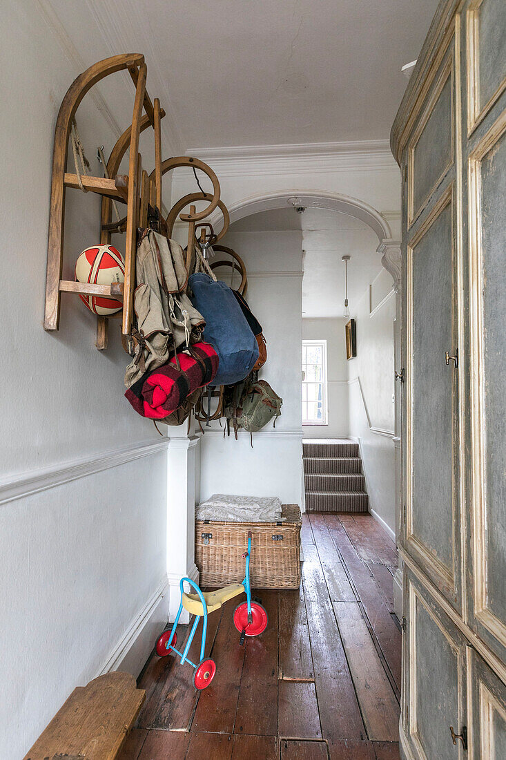 Wall mounted sledges in hallway of Winchester home UK