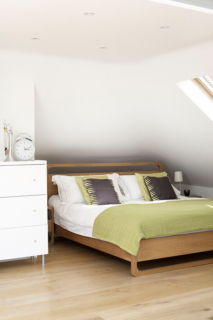 Double bed under eaves of attic conversion in London home