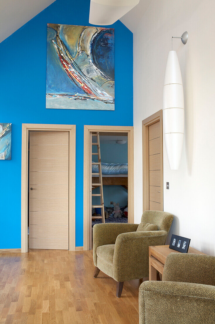 Artwork on bright blue feature wall of Isle of White holiday home