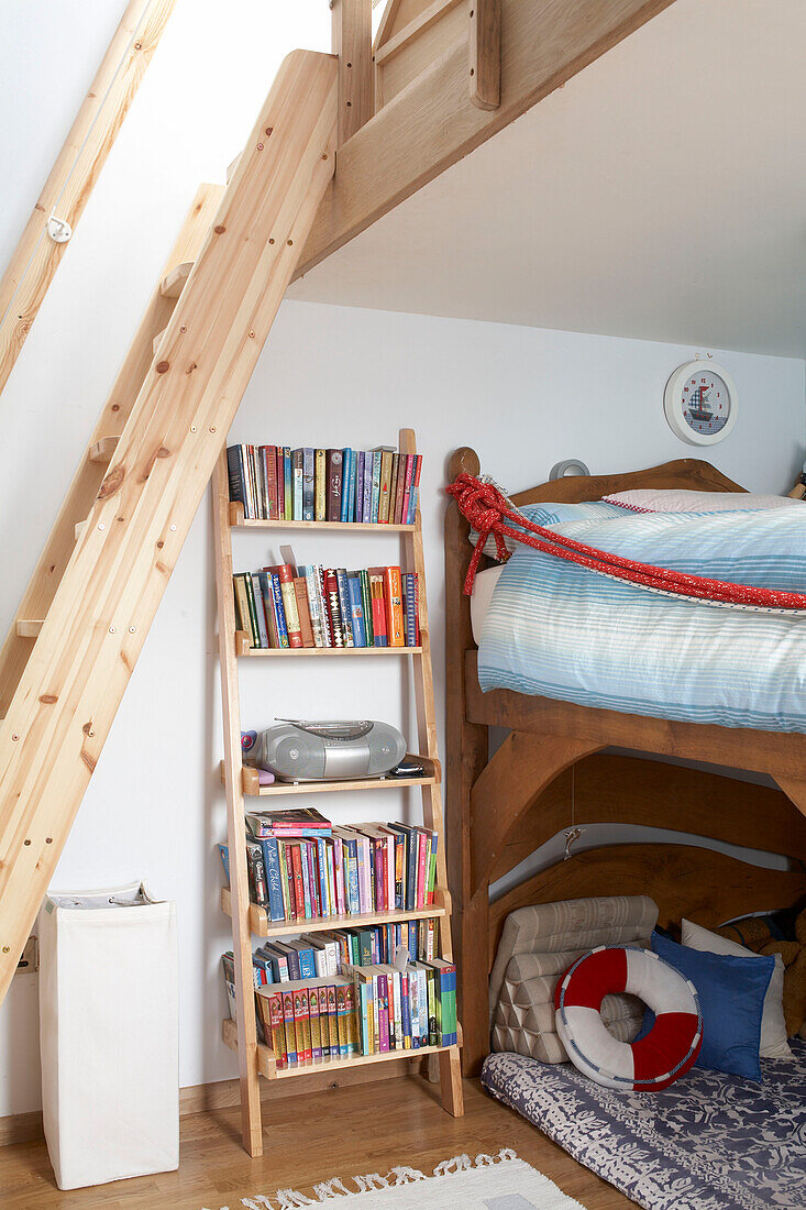 Wooden bunk bed with shelving unit below mezzanine in Isle of White home