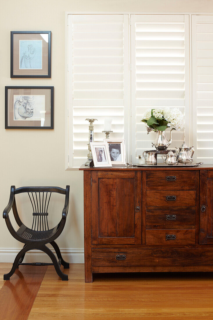 Wooden sideboard and louvered shutters in Sydney home Australia
