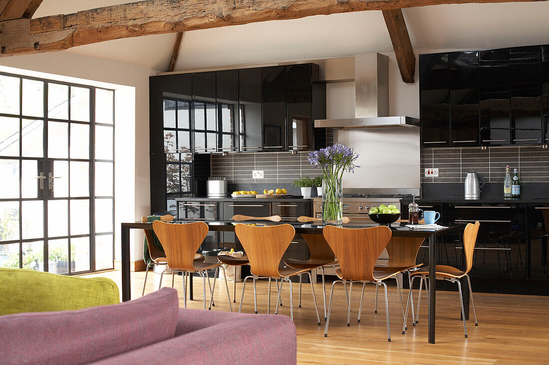 Beamed dining and kitchen area of Welsh barn conversion