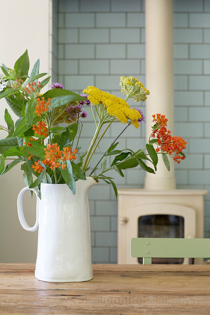 Cut flowers and wood burning stove in East Sussex
