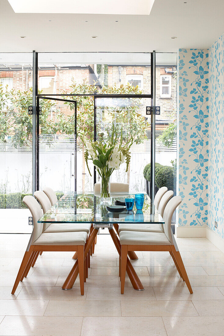 Cut flowers on dining table in London kitchen extension