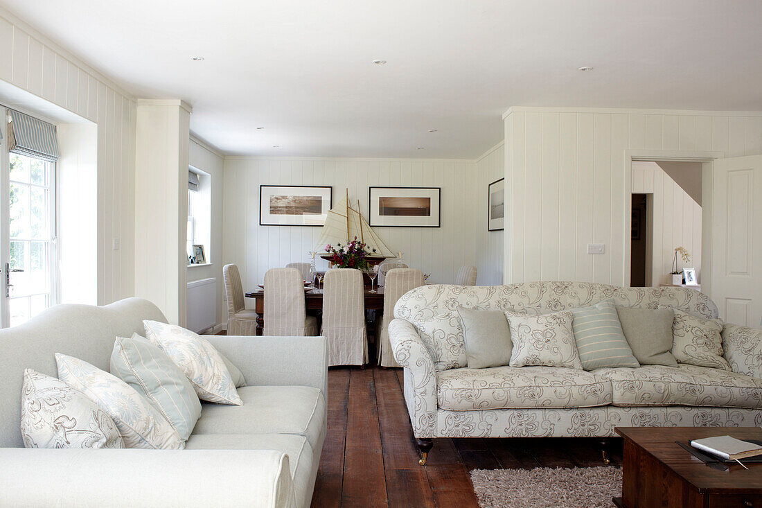 White painted open plan living and dining room in Bembridge farmhouse, Isle of Wight, England, UK