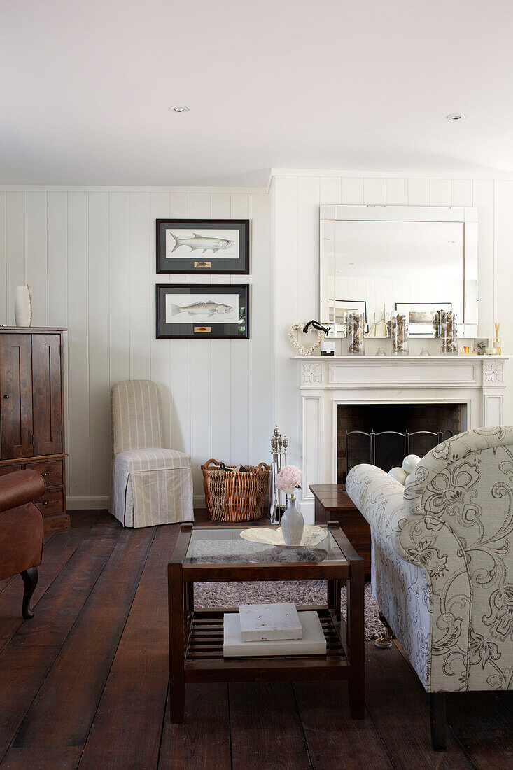 Glass topped side table and sofa in living room of Bembridge farmhouse, Isle of Wight, England, UK