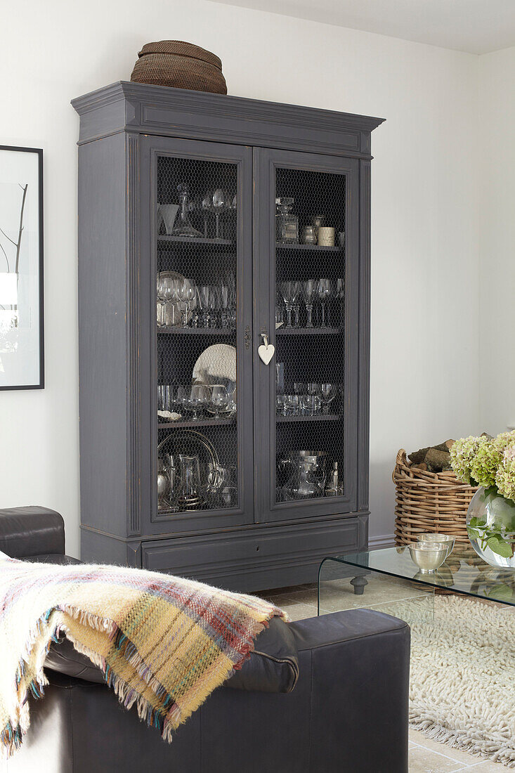 Grey painted cabinet for glassware in living room, Isle of Wight home, UK