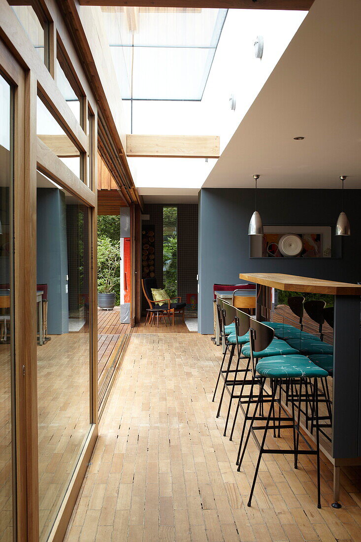 "Bar stools and skylight in kitchen with g;ass patio doors in contemporary Isle of Wight home UK"