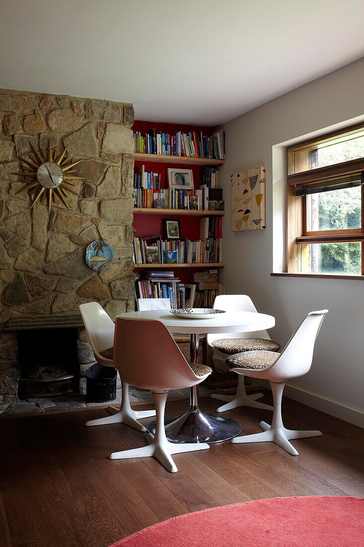 Eero Saarinen table and chairs with bookcase in contemporary new-build Isle of Wight home
