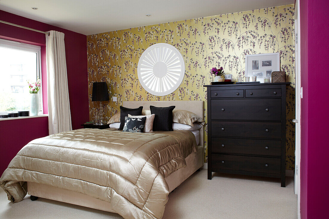Black tall-boy with pink and metallic accent in London bedroom England UK