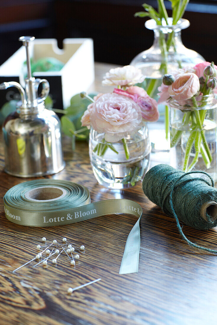 Cut flowers and floristry string on tabletop in Scottish apartment building UK