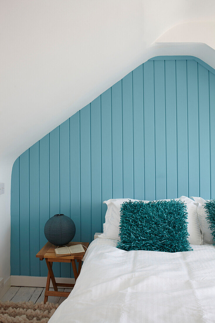 Attic bedroom in turquoise hues, contemporary Weymouth beach house, Dorset, UK