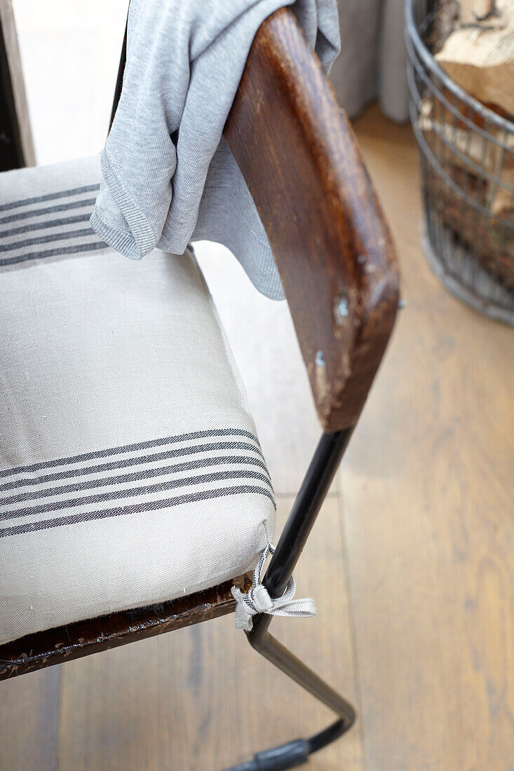 Striped seat cushion on vintage metal and wooden dining chair in Brighton home East Sussex UK
