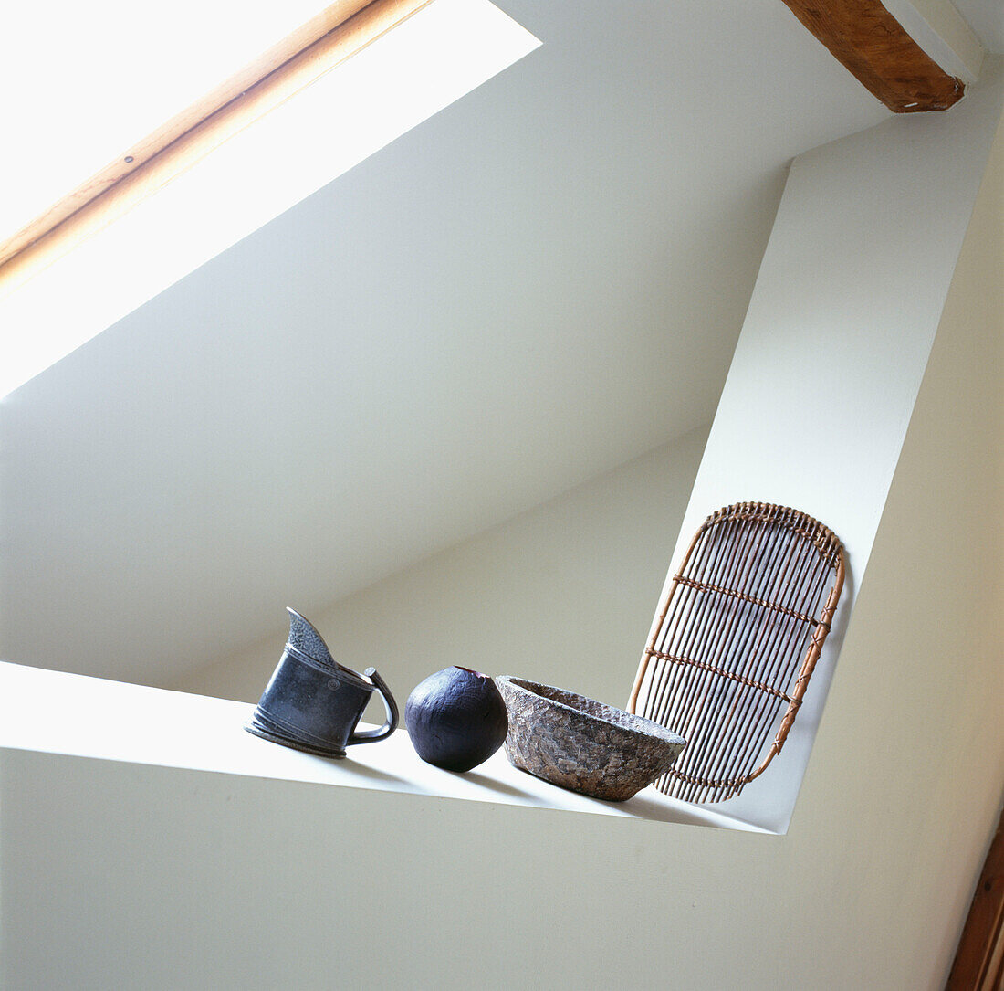Display of studio pottery and basket on a ledge in the bedroom 