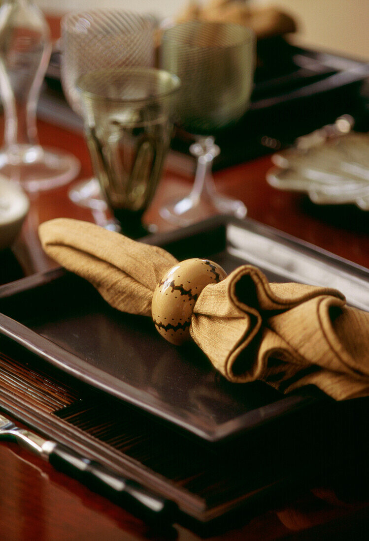 Detail of napkin on a square plate on table setting