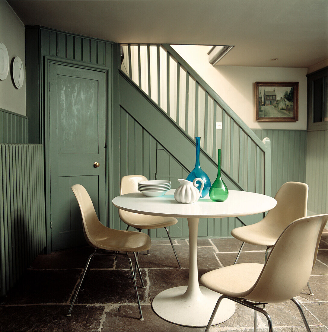Modern table and chairs in panelled hallway