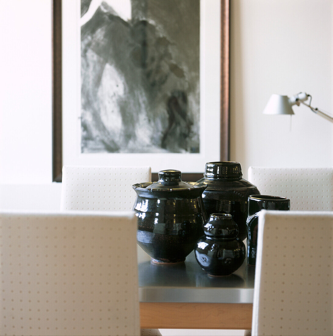 Black glazed stoneware pots on dining table