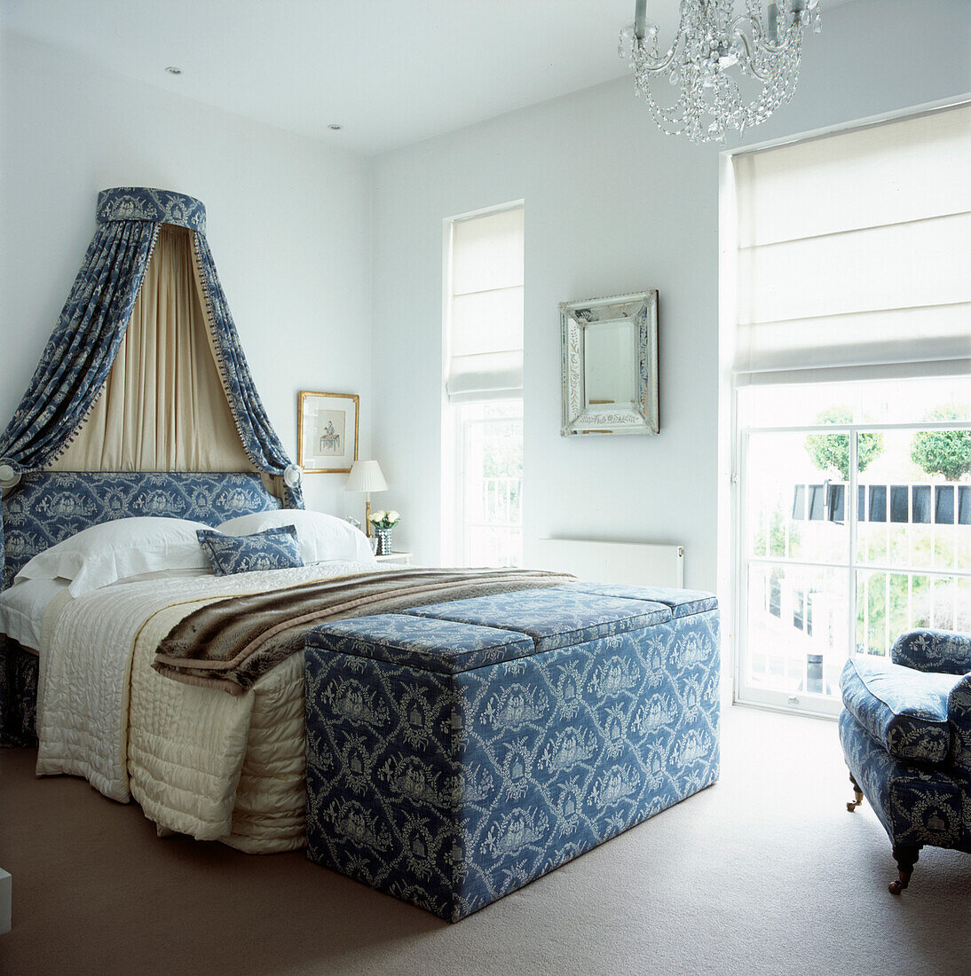White modern country style master double bedroom with matching soft furnishings and a bed canopy