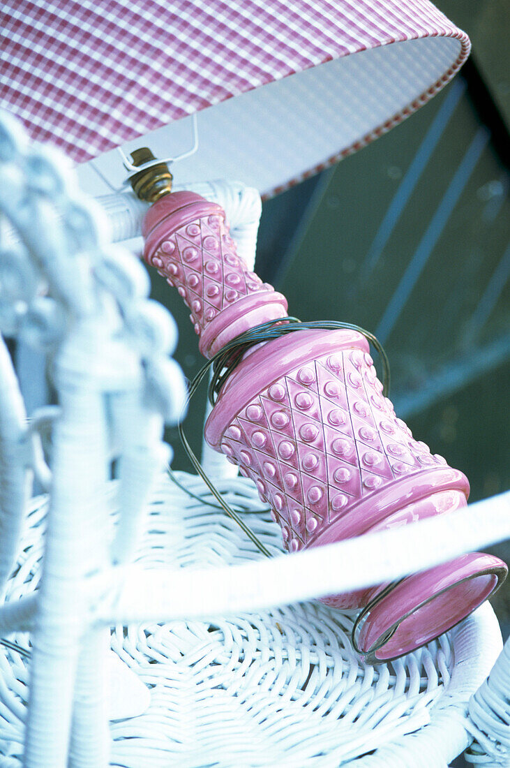Pink lamp on wicker chair