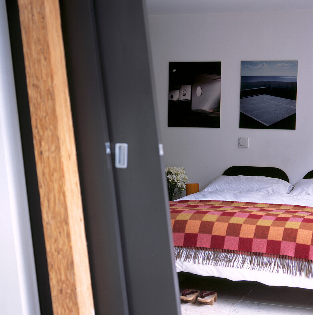 Detail of chocolate- painted wooden sliding doors leading to the bedroom