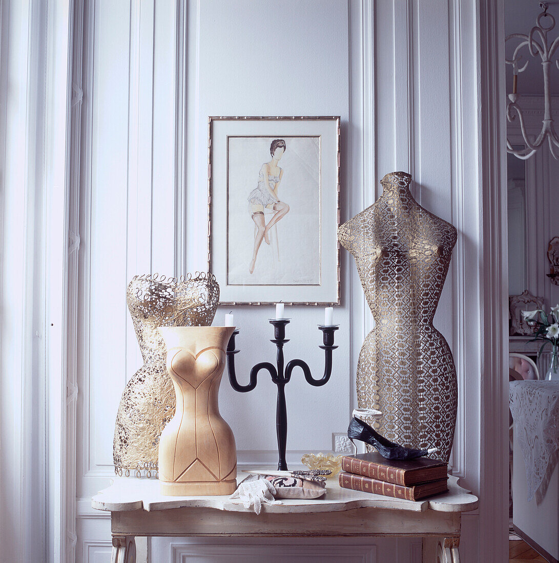 Tableaux of mannequins on side table in elegant panelled room