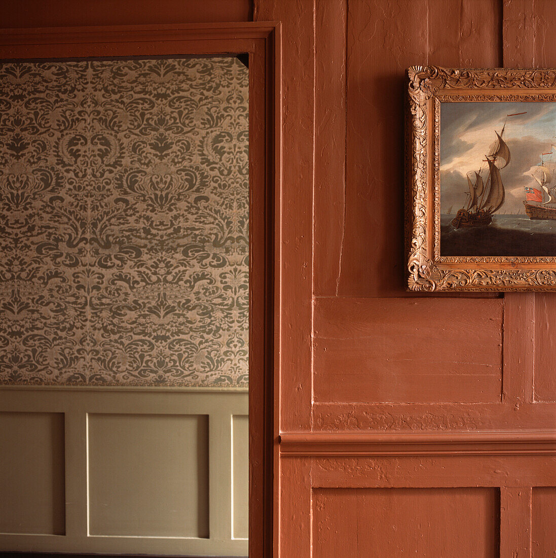 View of decorative wallpaper from the doorway of a panelled room in a restored Huguenot Spitalfields house