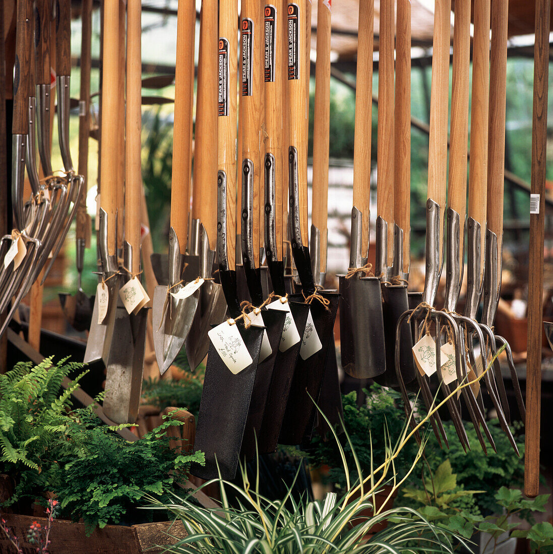 Garden tools hanging on display in garden center