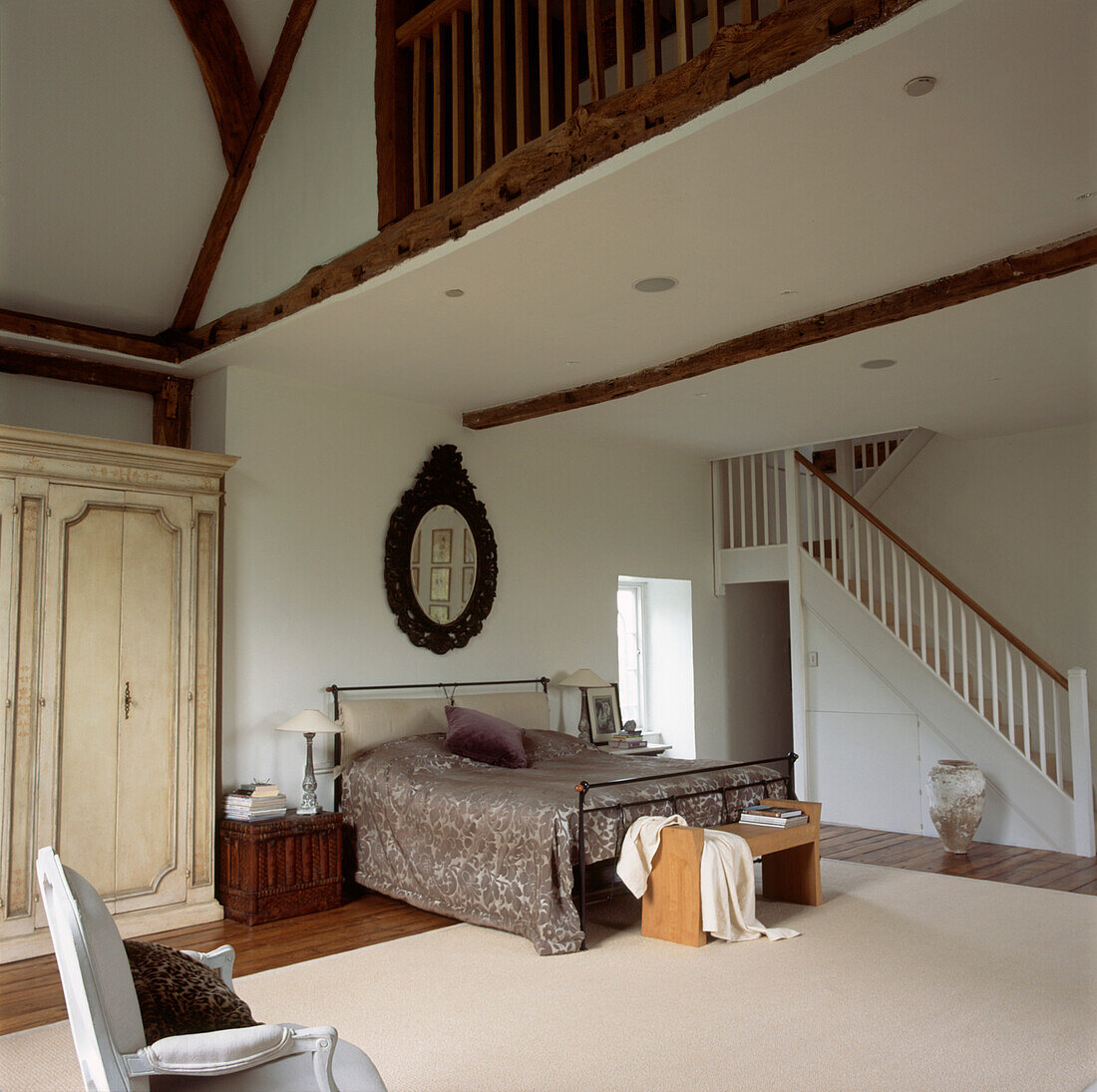 Large Bedroom with mezzanine staircase double bed in neutral colours