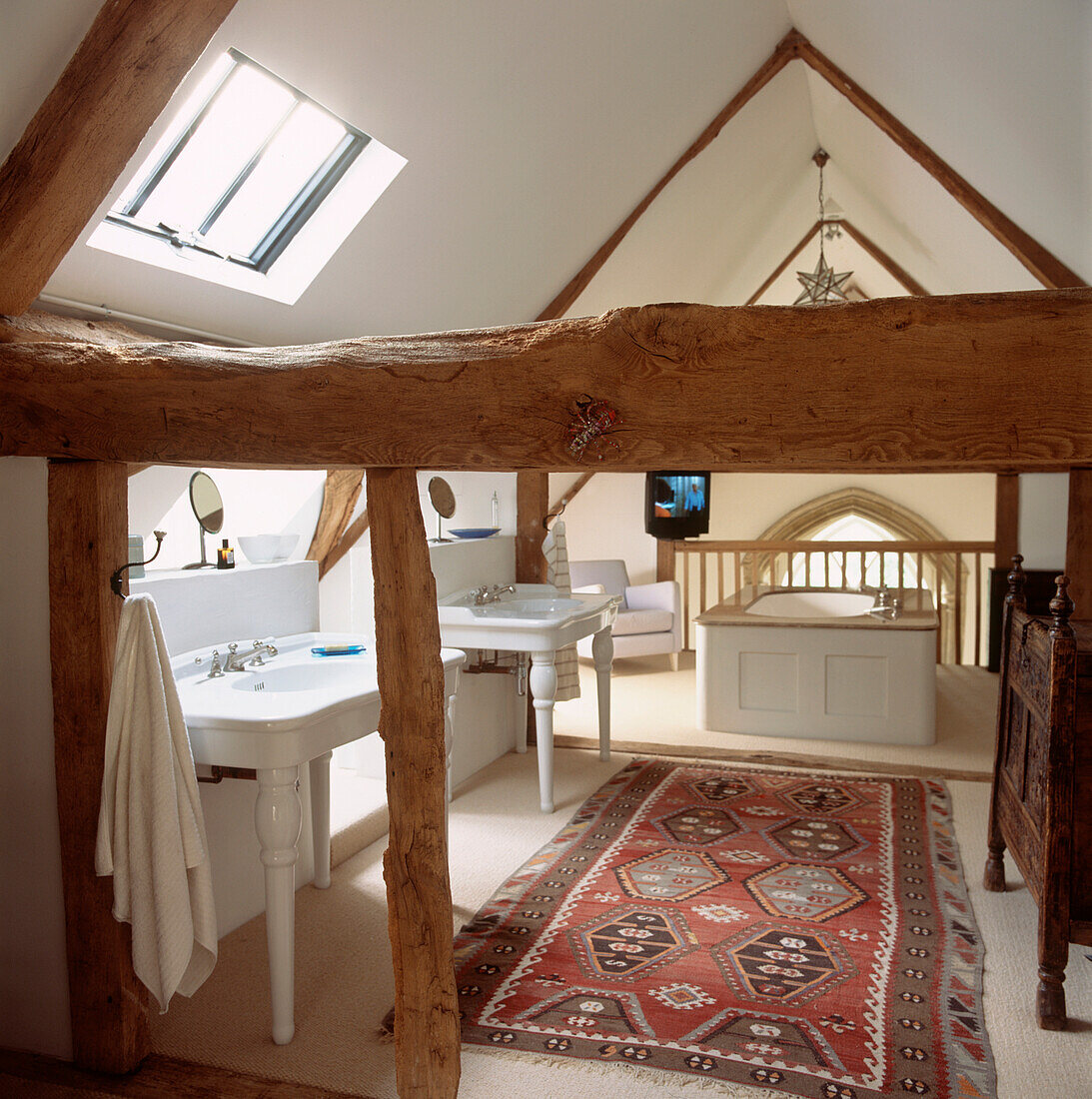 Attic bathroom with low level oak beams and apex roof