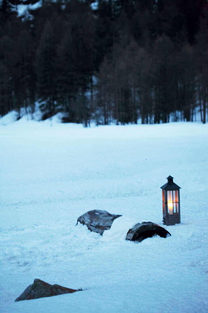 Lit lantern in snow, Zermatt, Valais, Switzerland