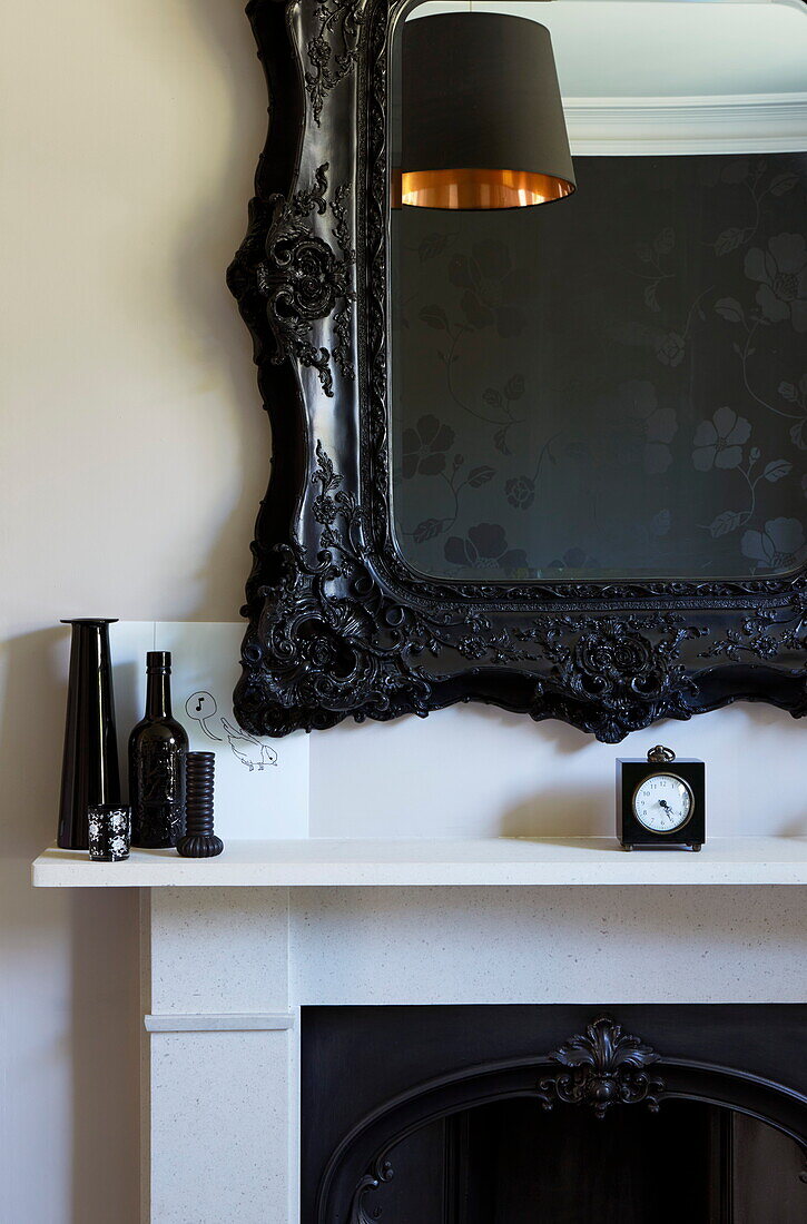 Black vases and mirror frame above mantlepiece in London townhouse, England, UK