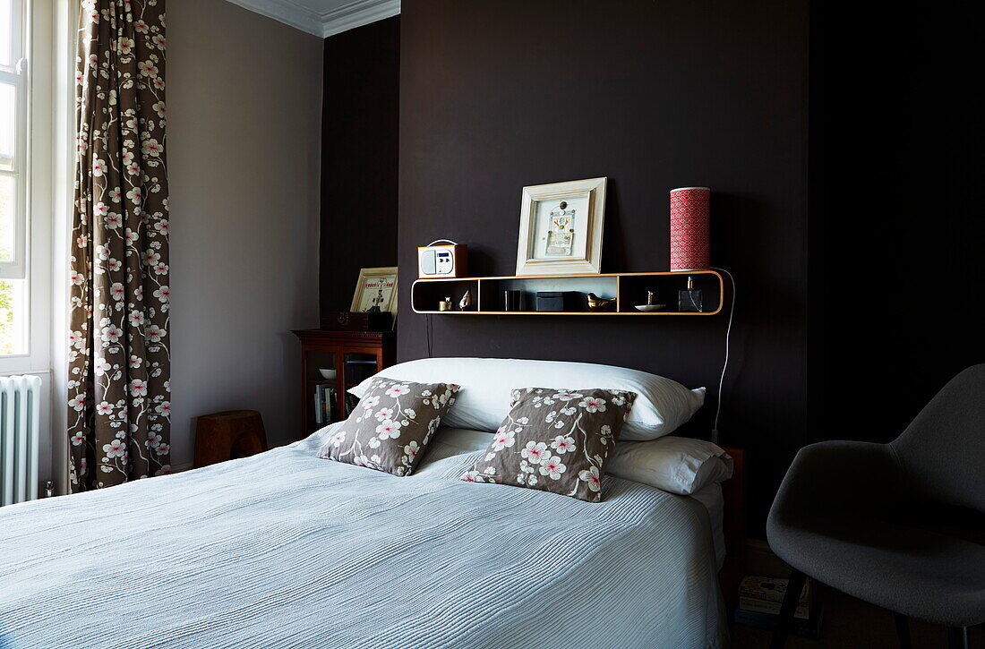 Co-ordinated floral fabrics in bedroom of London townhouse, England, UK