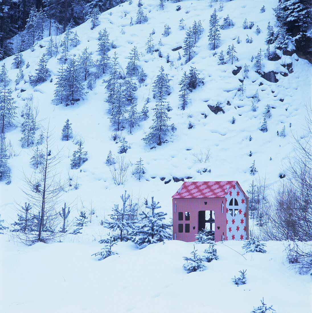 Festive play house decorated with fabrics and wallpaper in snowy mountains