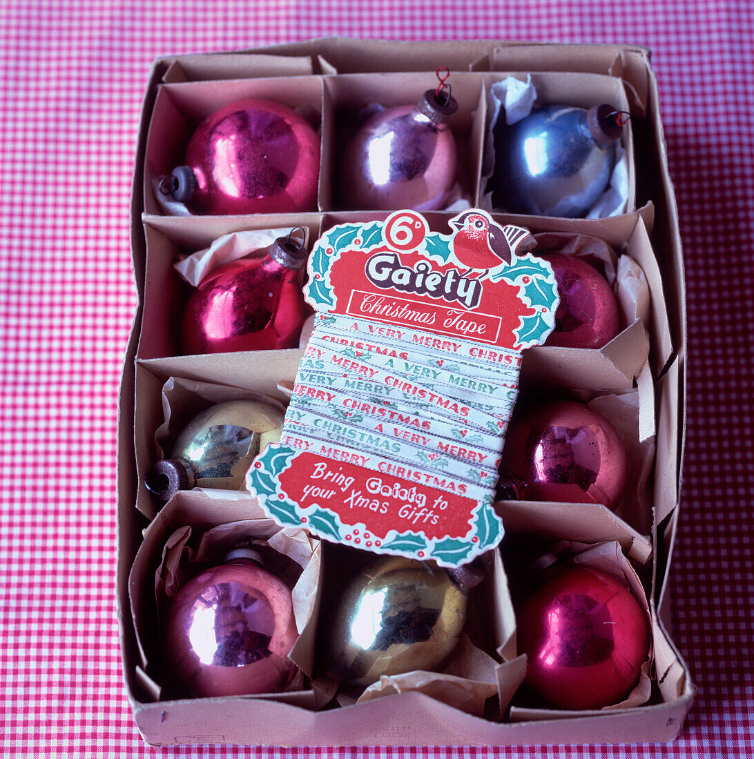Vintage baubles and tape in a box