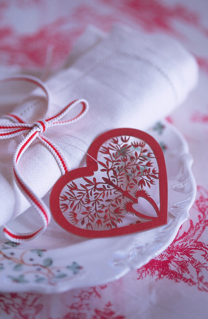 Christmas place setting with red heart and ribbon
