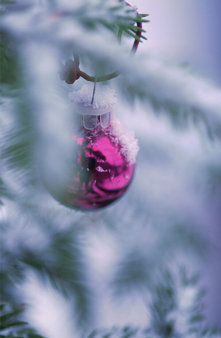 Holzstuhl mit brennender Kerze und Weihnachtskranz