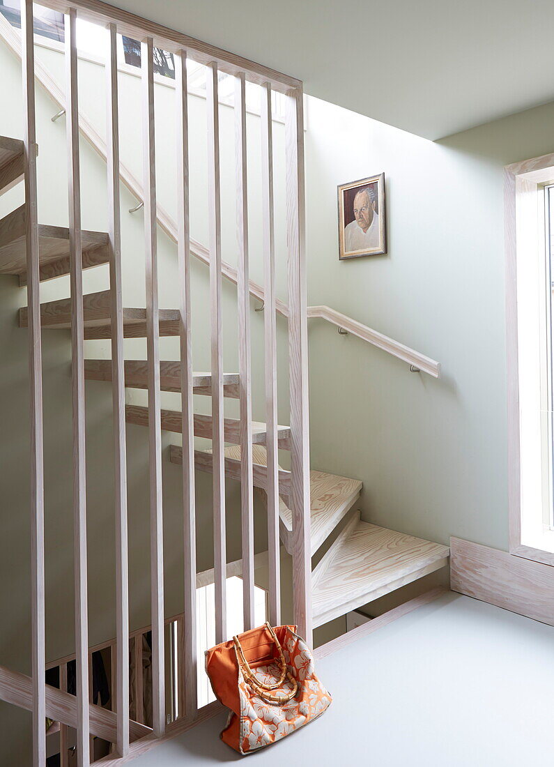 Limed wooden staircase and banister in contemporary London home, England, UK