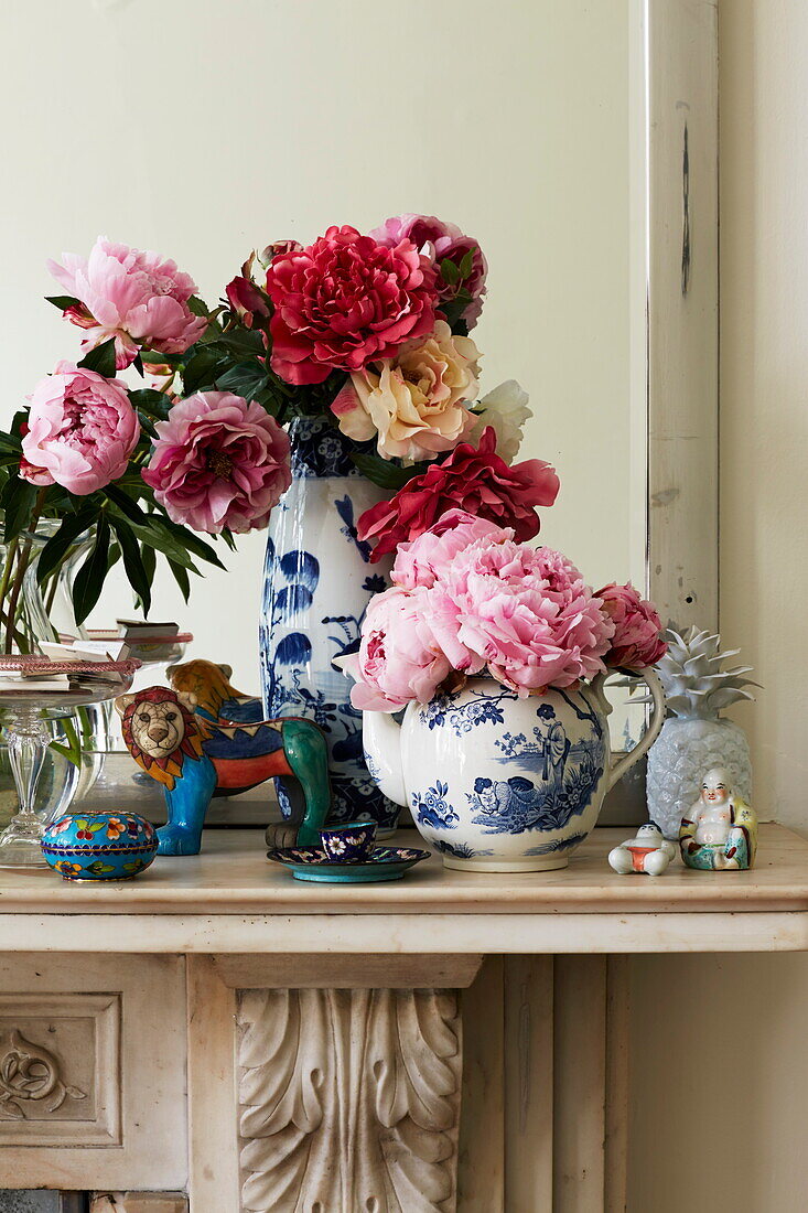 Cut flowers in chinaware on mantlepiece in London townhouse, England, UK