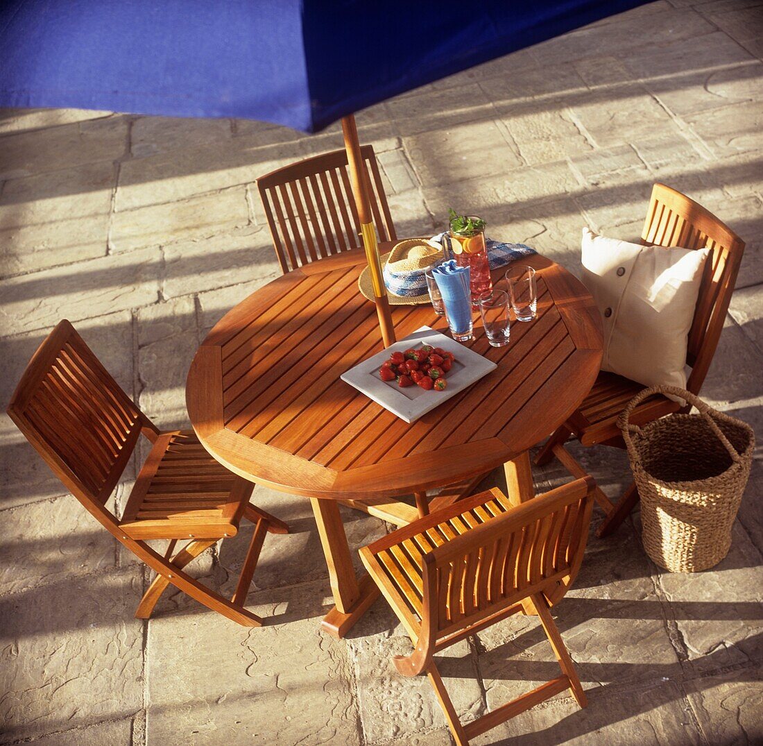 Hölzerner Picknicktisch unter Sonnenschirm