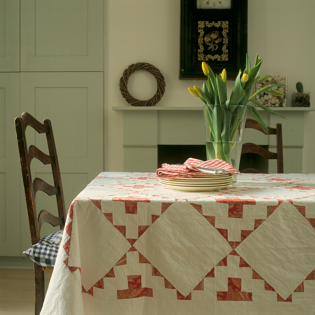 Red and white quilt in soft grey Shaker style dining room