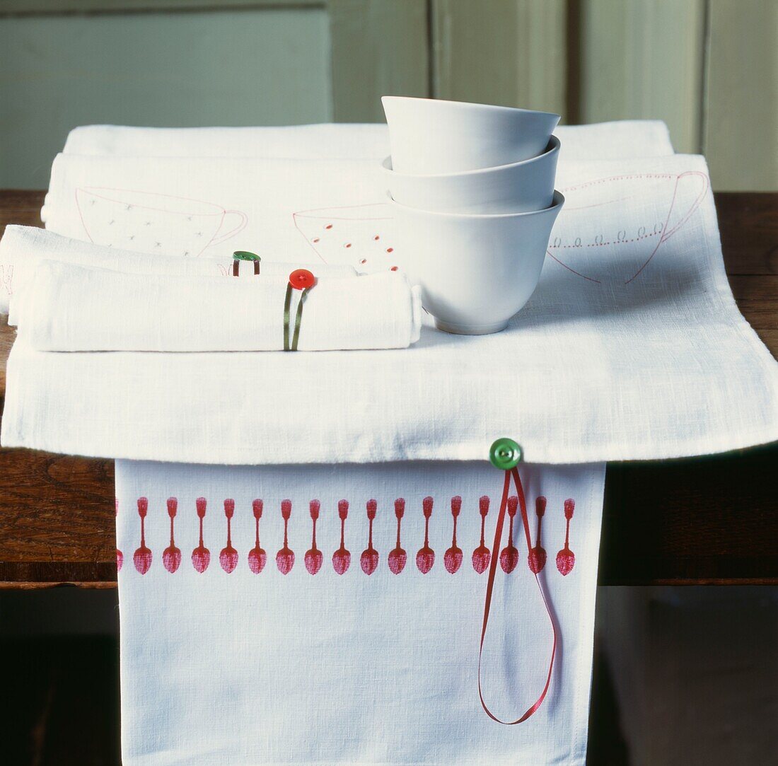 White bowls on place mat with hand finished napkins