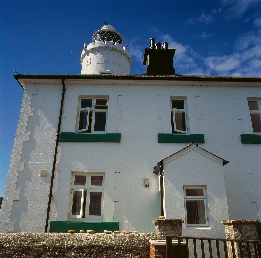 Whitewashed facade of lighthouse with contrasting window ledges