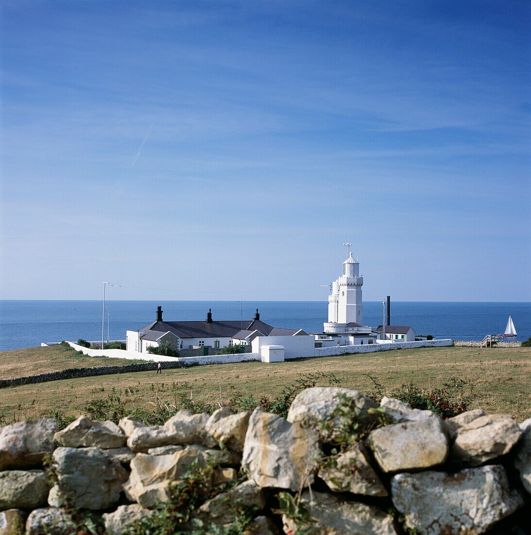 Rural lighthouse and dry stone wall