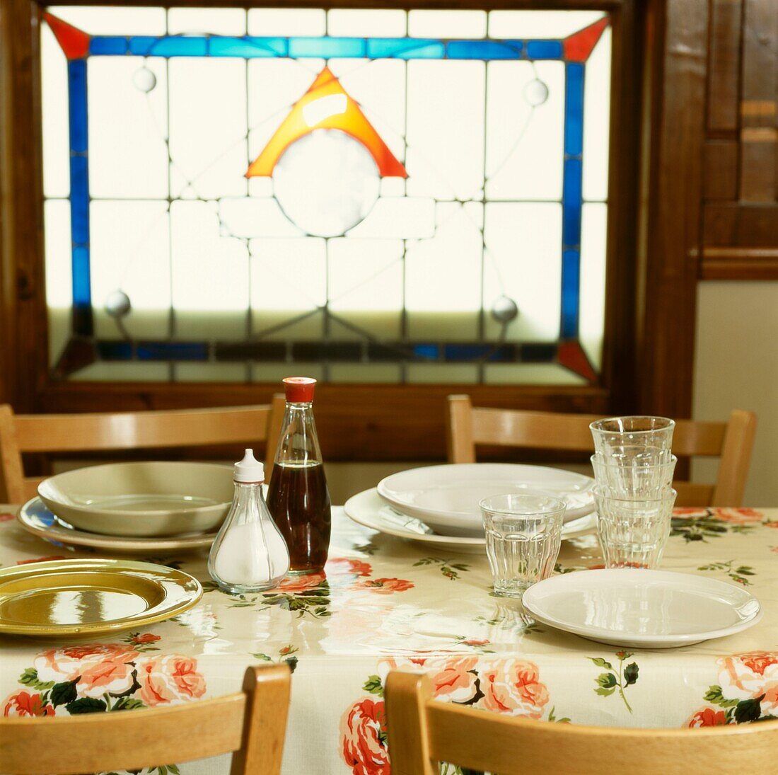 Place settings in cafe with stained glass window