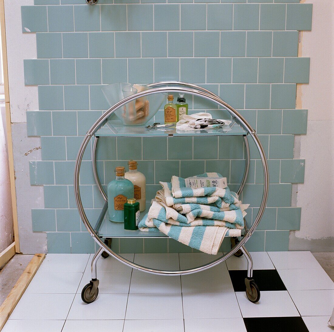 Freestanding bathroom unit in partially tiled room