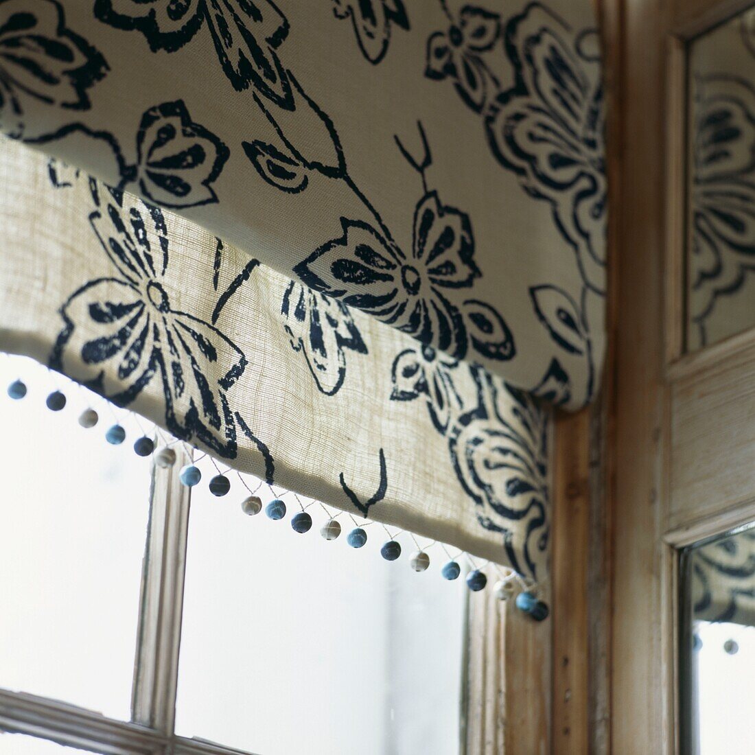 Floral patterned roman blind at window